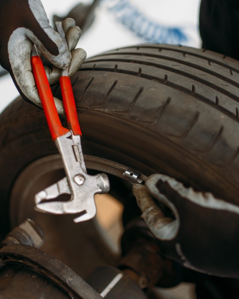 Close-up of a wheel being balanced in a mobile tire service unit