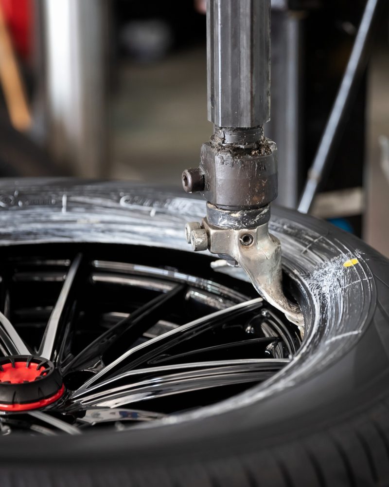 Technician performing a mobile tire change in a residential driveway in the GTA Greater Toronto and Hamilton Area